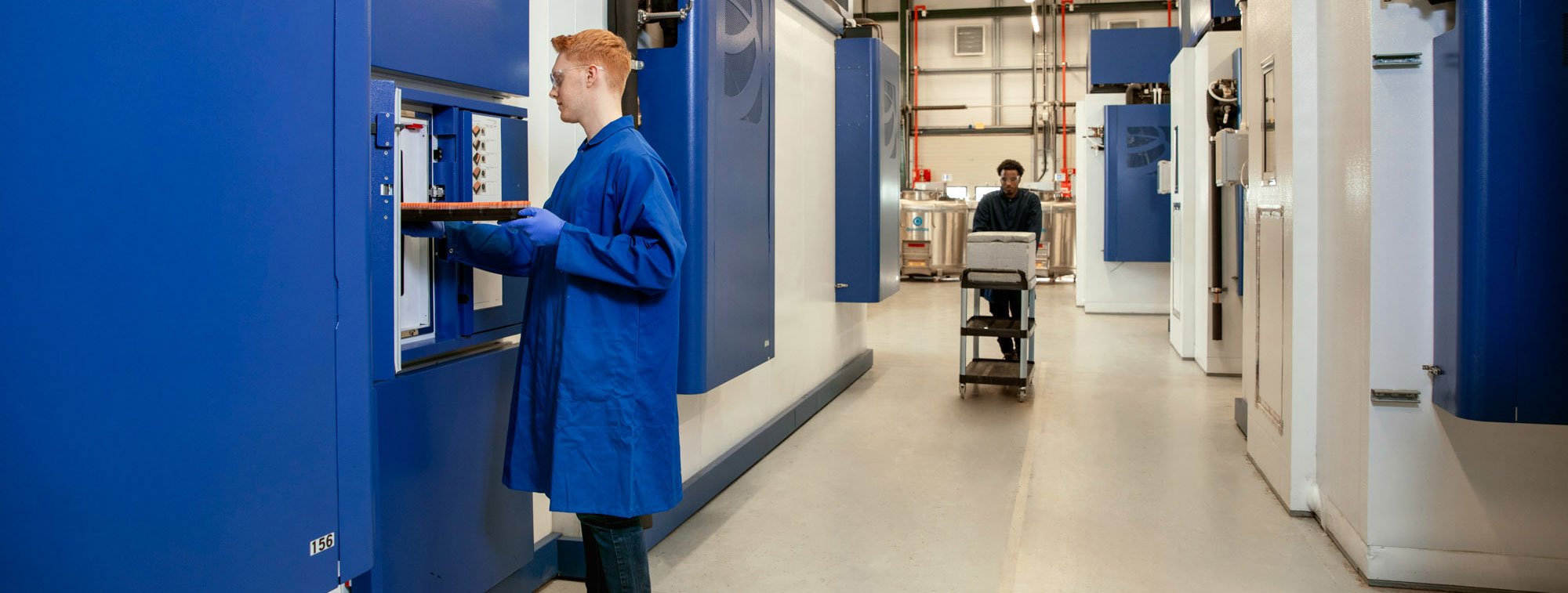 Technician operating Quad bank automated sample stores.